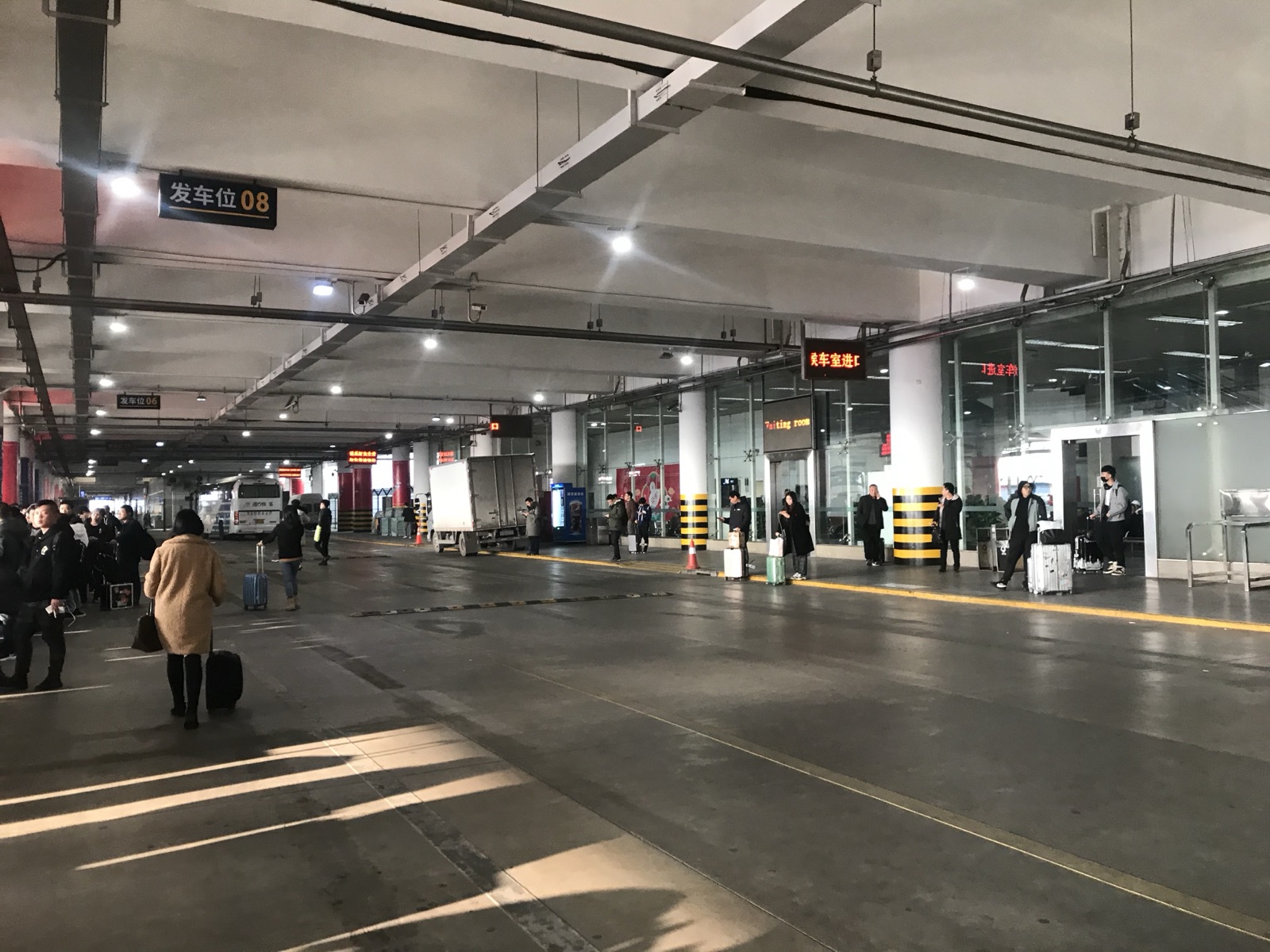 The airport bus boarding area at Hangzhou Xiaoshan Terminal 3, with numbered gates and a waiting area.